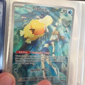 Misty’s Psyduck illustration art, Z,s Zoroark Ex gold card play bonus card